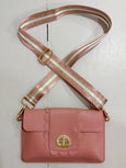 Pink handbag with gold accents on a white background