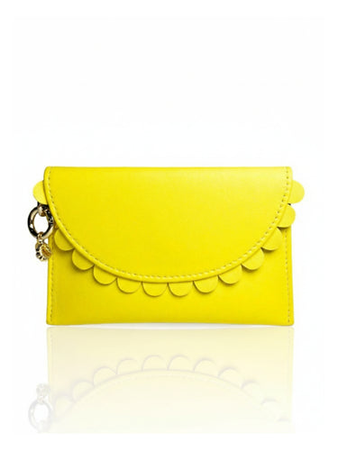 Yellow clutch bag with scalloped edge on a white background