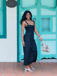 Elyse & i Theo Knot shoulder bag carried by model in black dress.
