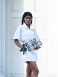Model in white outfit wearing a crossbody bag by Elyse & i called Theo Knot.