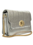 Silver handbag called Otis Shell by Elyse & i with a gold chain and clasp on a white background