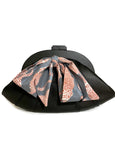 Black Elyse & i Dawn Scallop handbag with a patterned bow on a white background