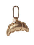 Gold croissant shaped leather keychain with carabiner on a white background by Elyse & i