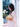 Woman holding a bouquet of flowers and a gold Elyse & i Dawn Scallop clutch outdoors