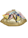 gold Elyse & i Dawn Scallop clutch with a colorful floral bow on a white background