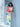Woman in a colorful dress holding a red Elyse & i Finn Scallop clutch on a white railing.