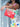 Person holding a red Elyse & i Finn Scallop clutch bag with a colorful dress in the background