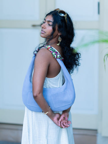Woman carrying a light blue Martha sling bag by Elyse & i outdoors