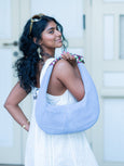 Woman carrying a light blue hobo Martha bag by Elyse & i outdoors