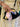 Person holding a black clutch with colorful fabric accents - the Dawn Scallop bag by Elyse & i