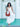 Woman in a white dress holding a brown Elyse & i Martha Suede Hobo bag in terracotta suede against a light blue wall.