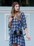 Elyse & i Nell Knot bag with chain, in black & gold lambskin leather on model worn as crossbody.