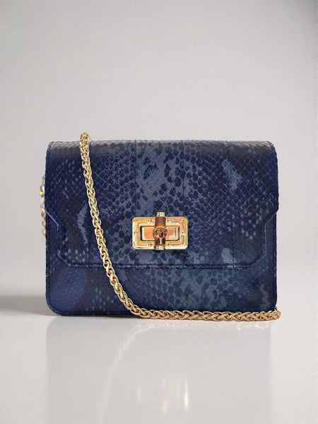 Blue snakeskin pattern handbag with gold chain strap on a light gray background