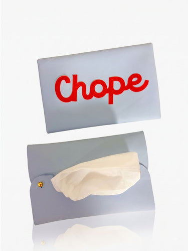 baby blue leather tissue holder with the slogan ' CHOPE' on it.