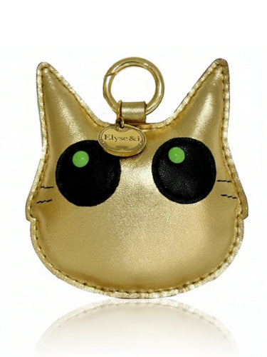 Gold cat-shaped keychain with green eyes on a white background