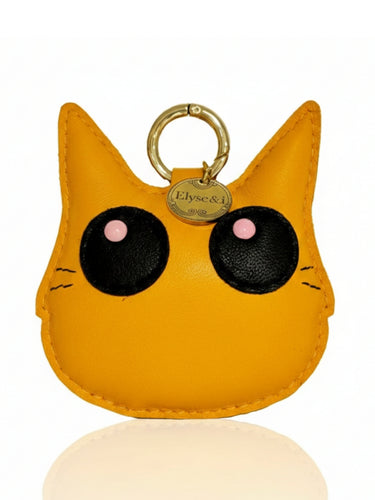Orange cat-shaped keychain with black eyes and pink cheeks on a white background