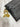Black leather wallet with gold keychain on a marble surface