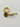 Gold charm with a fish design on a light gray background