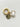 Gold charm with a white oval and round tag on a light gray background