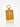 An orange leather luggage tag featuring a white Chinese character 'Zhong' in the center, attached to a gold metal key ring, set against a clean white background with a soft reflection below.