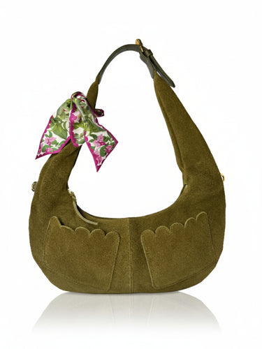 Green suede handbag with a floral scarf on a white background