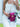 Person holding a pink handbag with a floral strap against a white background