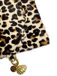 Elyse & i Bella Purse Scallop Leopard print fabric with gold charm and shell pendant on a white background