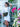 Woman in a white dress with a green bag standing in front of a decorative white gate with flowers.