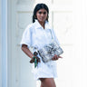 Model in white outfit wearing a crossbody bag by Elyse & i called Theo Knot. 