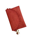 Bella Scallop by Elyse & i  in terracotta brown suede with ruffled edge and decorative charm on a white background
