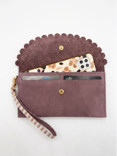 Inside view of a mauve purple purse showing it holds a phone and cards. 
