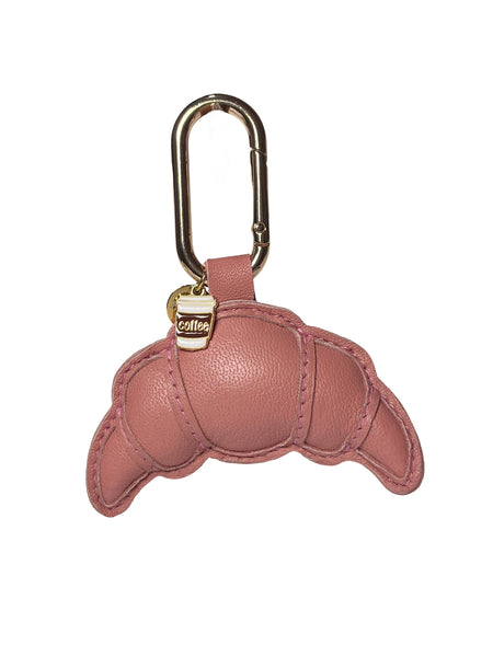 Pink leather keychain shaped like a croissant with a gold carabiner on a white background by Elyse & i 