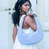 Woman holding a light blue Martha Scallop bag by Elyse & i with a white background
