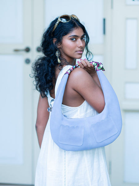 Woman holding a light blue Martha Scallop bag by Elyse & i with a white background