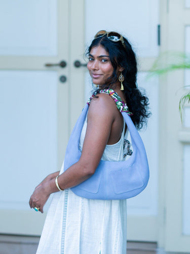 Woman holding a light blue Martha handbag by Elyse & i  in an outdoor setting