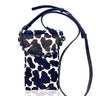Small pouch with cow print pattern and black strap on a white background