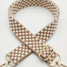 Patterned strap with gold hardware on a white background