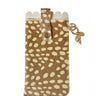A small brown and cream spotted glasses case with a flap closure, shown on a white background with a faint reflection below. A small gold-toned charm hangs from the side.