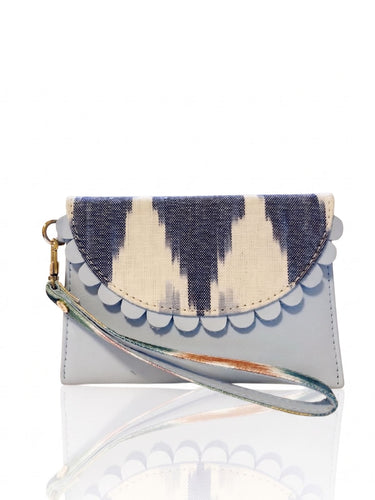 Handbag with a patterned flap on a white background