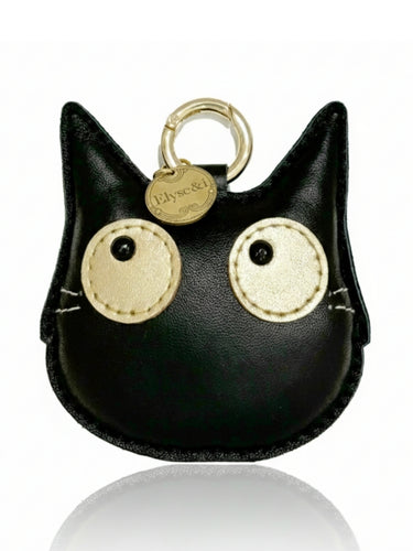 Black cat-shaped keychain with gold accents on a white background