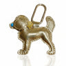 Gold dog-shaped keychain with a blue nose on a white background