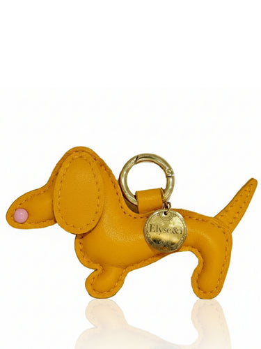 Orange dog-shaped keychain with a gold tag on a white background