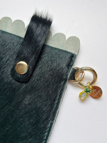 Close up glasses case in forest green with pineapple charm