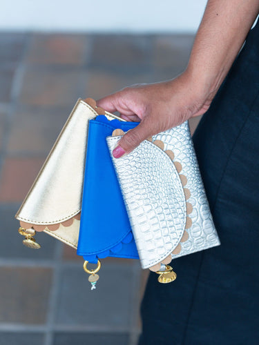 Person holding three Bella purses with charms from Elyse & i