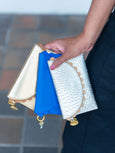 Person holding three Bella purses with charms from Elyse & i