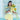 Woman in a yellow outfit holding sunflowers and a gray handbag against a decorative wall.